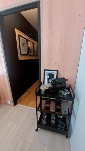 a black cart in a hallway with a mirror at Le Parc in Sarcelles