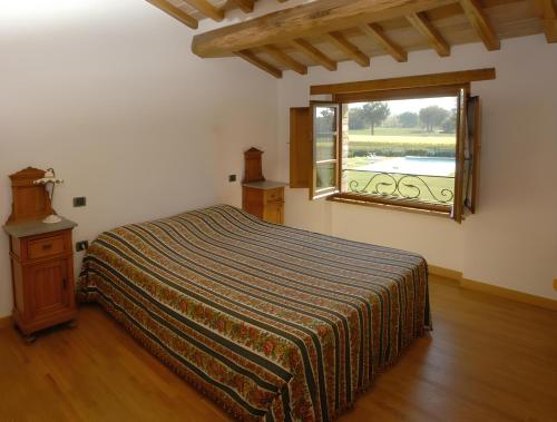 a bedroom with a bed and a window at Ca' Matra in Lama