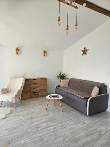 a living room with a couch and a table at Moon Lake Bicaz - Casa Imero in Buhalniţa