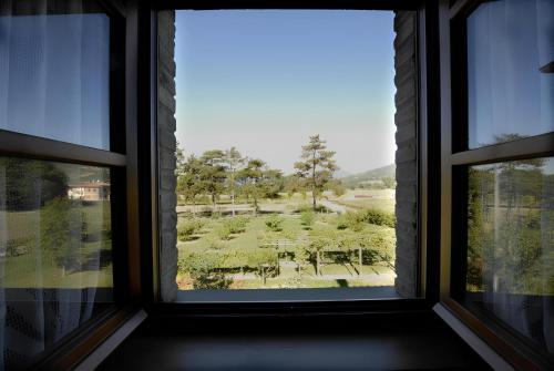 a window with a view of a park through it at Ca' Matra in Lama