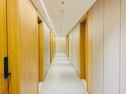 a hallway with wooden walls and a long corridor at Dayin Garden Hotel -People's Square & Nanjing Road-Large Social Area -Bar -Café -Gym -Free Laundry Luggage Storage -24H Front Desk-English Service in Shanghai
