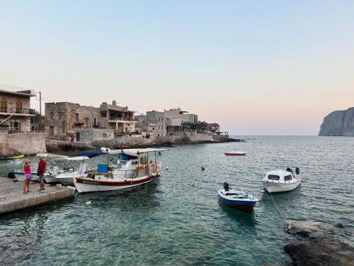 a group of boats are docked in a body of water at Pedra in Gerolimenas