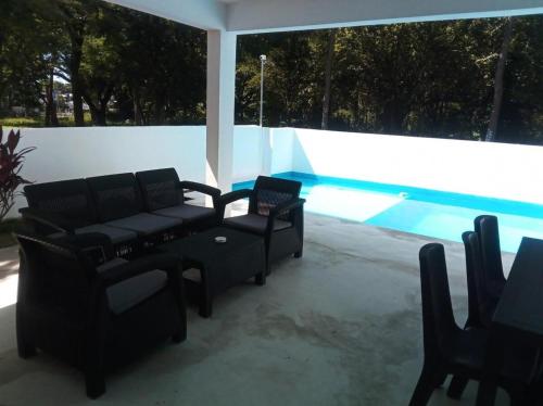 a group of chairs sitting next to a swimming pool at villa caraibica piscina privata in Sosúa