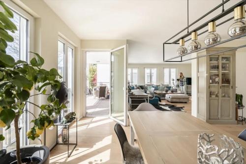 a dining room with a table and a living room at Luxuszimmer für hohe Ansprüche in Baden-Baden