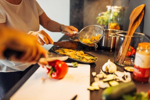 a group of people preparing food in a kitchen at harry's home Zürich-Limmattal in Spreitenbach