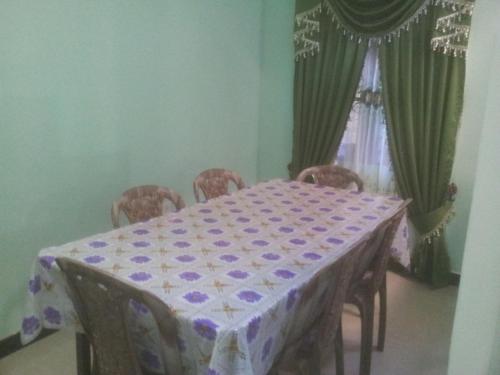 a dining room table with a purple and white table cloth at veranda guest home in Mirissa
