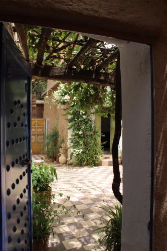 an open door to a courtyard with a patio at Maison Berber Ouirgane in Ouirgane