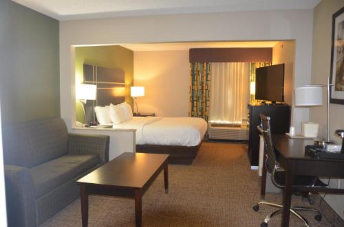 a hotel room with a bed and a desk at Comfort Inn & Suites Maumee - Toledo I80-90 in Maumee