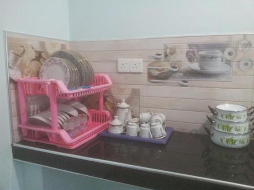 a toy kitchen with dishes and other items on a shelf at veranda guest home in Mirissa