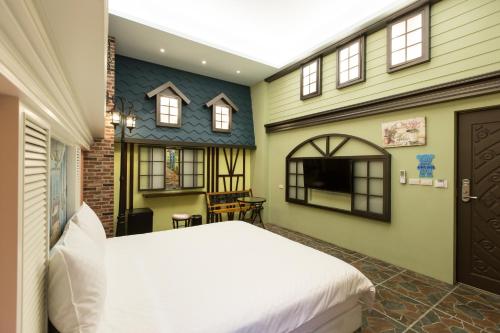 a bedroom with a bed and a house at Bookline B&B in Hualien City