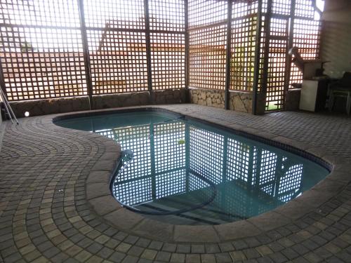 a small swimming pool with a fence around it at Sensual Sanctuary Boutique Spa in Witbank