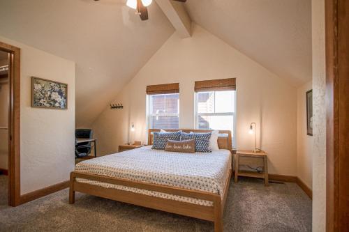 a bedroom with a bed with blue pillows and a window at Dover Bay Way in Dover