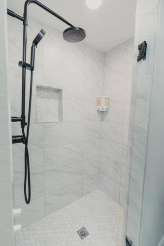 a bathroom with a shower with a glass door at R&Rcade- Hot Tub, Arcade, Candy Machine, Gazebo in University Place