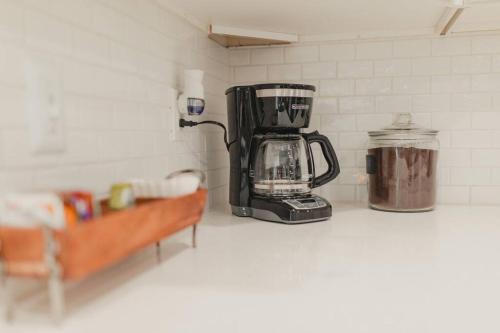 a coffeemaker on a counter with a coffee pot at R&Rcade- Hot Tub, Arcade, Candy Machine, Gazebo in University Place