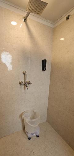 a bucket in a bathroom with a faucet at Baba Palace - A Heritage Hotel, Udaipur in Udaipur