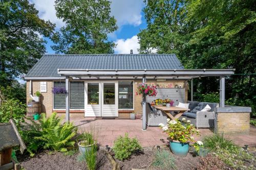 patio sul retro con pergolato e tavolo di Landhuisje 31 'De Akkersteen' Bospark IJsselheide Zwolle Hattemerbroek a Hattemerbroek