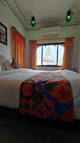 a bedroom with a large bed and a window at Baba Palace - A Heritage Hotel, Udaipur in Udaipur