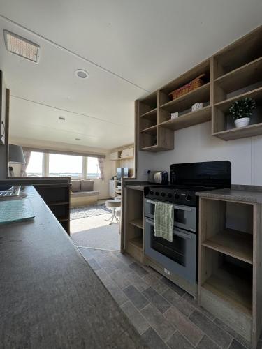 a kitchen with a stove and a counter top at Perranporth Coastal Retreat- Sleeps8 in Perranporth