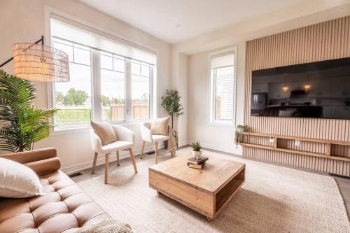 a living room with a couch and a coffee table at Spotless 5 bed and 4 bath with Wi-Fi and 1hr to Niagara in Hamilton
