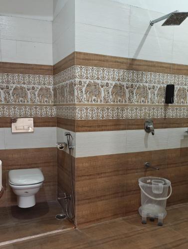 a bathroom with a toilet and a shower at Baba Palace - A Heritage Hotel, Udaipur in Udaipur