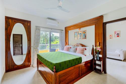 a bedroom with a bed and a large window at Alaya Stays 1 BHK with Balcony & Pool - Veera Marina in Goa
