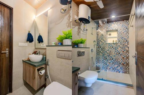 a bathroom with a toilet sink and a shower at Alaya Stays 1 BHK with Balcony & Pool - Veera Marina in Goa