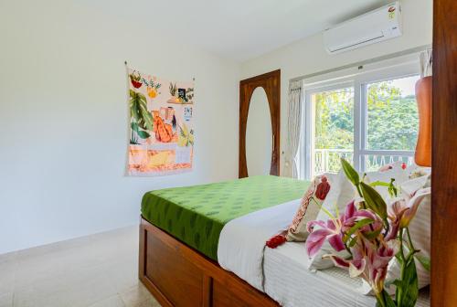 a bedroom with a bed and a window at Alaya Stays 1 BHK with Balcony & Pool - Veera Marina in Goa