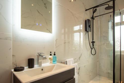a white bathroom with a sink and a shower at Britannia Apartments in Liscard Village Wallasey by Rework Accommodation in Wallasey