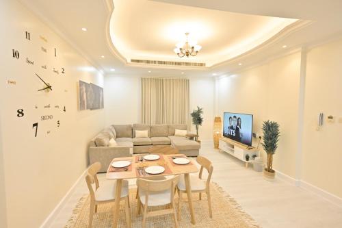 a living room with a table and a couch at RJ's - Beautiful 3 Bedroom Apartment in Al Khobar