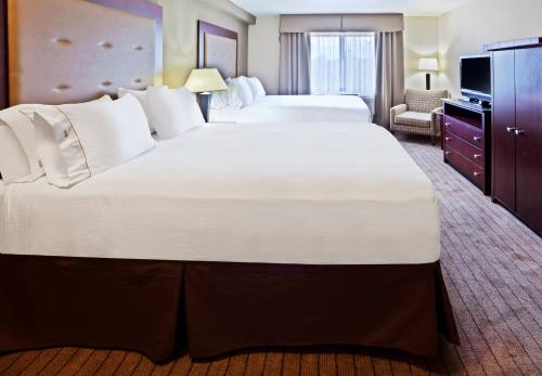 a hotel room with two beds and a television at Holiday Inn Express Portland South - Lake Oswego by IHG in Lake Oswego