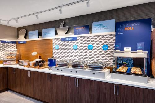 a bakery with a counter with pastries on it at Holiday Inn Express Portland South - Lake Oswego by IHG in Lake Oswego