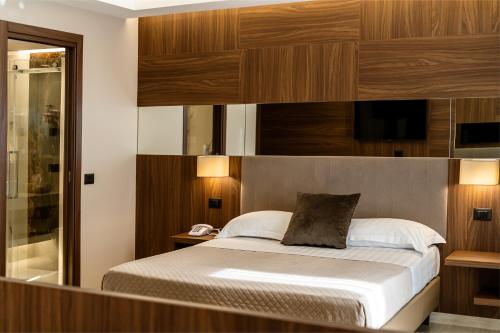 a bedroom with a bed with wood paneled walls at Hotel Bellavista in Marina di Varcaturo
