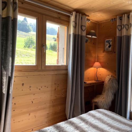 a bedroom with a bed and a window at Chambres à la ferme au pied des pistes de Megève in Demi-Quartier
