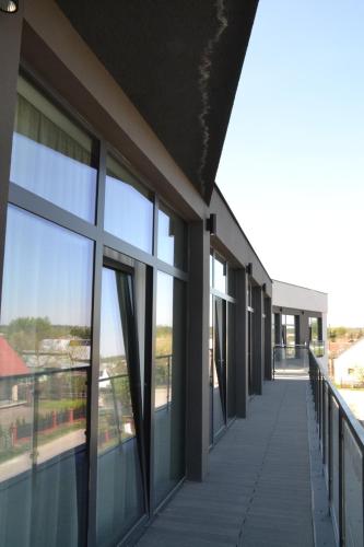 an empty walkway in a building with windows at Soccer Box Pro in Dachnów