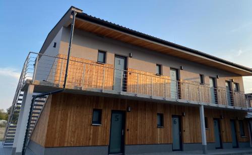 a building with a balcony on the side of it at JK Apartmány in Bělkovice
