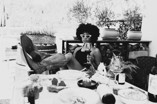 a woman wearing a mask holding a glass of wine at Adults Only Boutique-Hotel Unterlechner in Sankt Jakob in Haus
