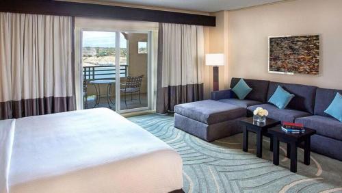 a hotel room with a bed and a couch at Lakeway Resort & Spa in Lakeway