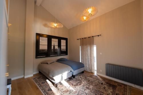a bedroom with a bed and a window at Belle grange en bord de rivière in Serres-sur-Arget