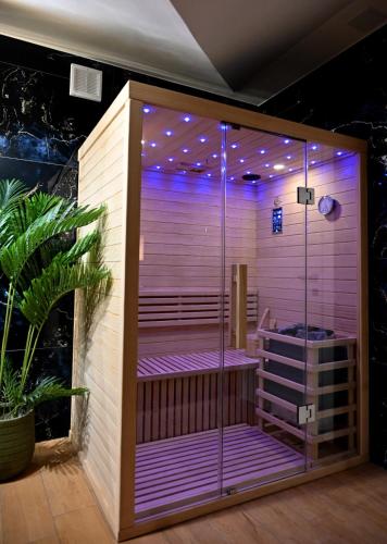 a bathroom with a shower with purple lighting at Mery in Slavonski Brod