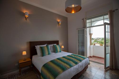 a bedroom with a bed and a large window at Appartements Balima Résidences Sidem in Rabat