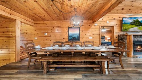 a wooden dining room with a wooden table and chairs at Applewood in Pigeon Forge