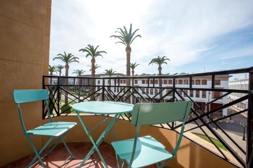 a balcony with a table and chairs and palm trees at Appartements Balima Résidences Sidem in Rabat