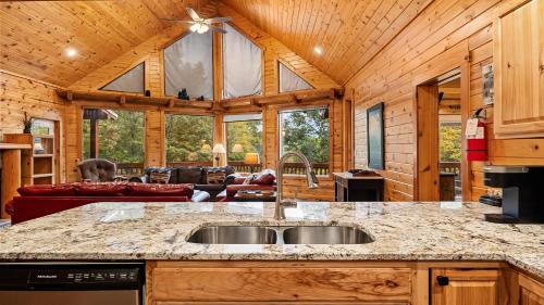 a kitchen and living room in a log cabin at Applewood in Pigeon Forge