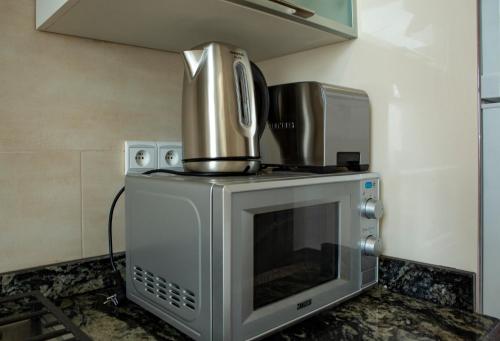 a kitchen with a stove with a pot on top of it at Appartements Balima Résidences Sidem in Rabat