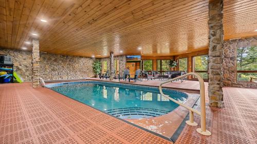 a swimming pool in a house with a wooden ceiling at Applewood in Pigeon Forge