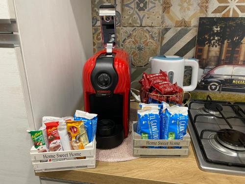 a kitchen counter with a stove and a bottle of wine and snacks at B&B Ladislaus in Ladispoli