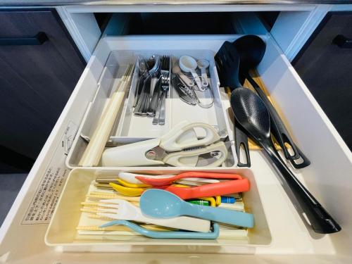 a drawer filled with utensils and utensils at Airport Right Fukuoka in Fukuoka