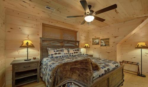 a bedroom with a bed in a log cabin at Experience Luxury and Serenity at 3 Little Bears Just Minutes from Top Attractions Private Indoor Pool Hot Tub in Pigeon Forge