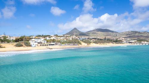 a view of a beach with mountains in the background at H2Ome by An Island Apart in Porto Santo