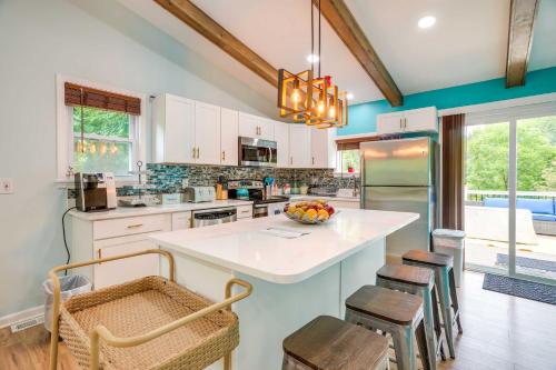 a kitchen with white cabinets and a kitchen island with chairs at Front Royal Retreat on 3 Acres with Mtn Views! in Front Royal